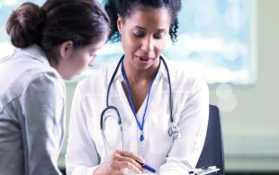 An Image of a healthcare professional helping a diabetes patient