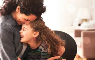 An Image of a mother hugging her child
